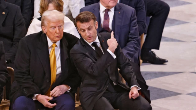 French President Emmanuel Macron, U.S. President-elect Donald Trump and Germany's President Frank-Walter Steinmeier sit inside Notre-Dame de Paris Cathedral