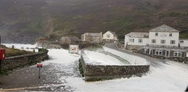 Waves and foam on sea and road and pub.