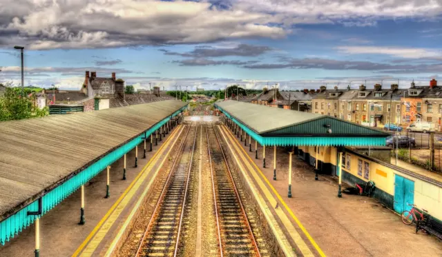 Aerial view of two platforms at Coleraine train station with buildings visible in horizon