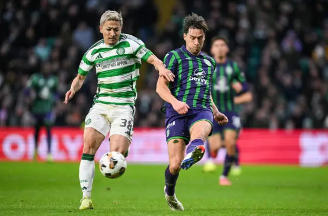 Daizen Maeda and Joe Newell battle for possession