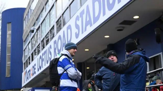 QPR fans chat outside Loftus Road