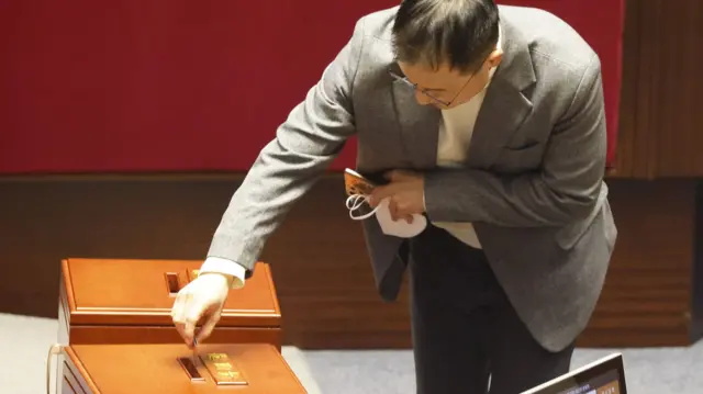 People Power Party (PPP) lawmaker Kim Sang-wook casts his vote on the impeachment motion against President Yoon Suk Yeol at the National Assembly in Seoul, South Korea