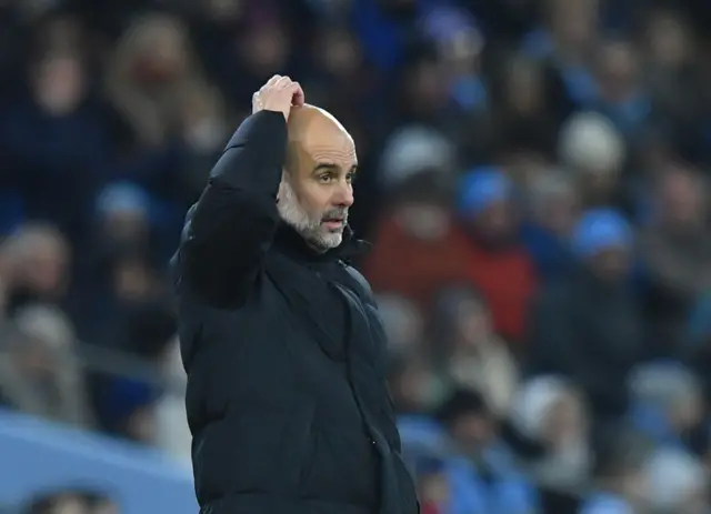 Pep Guardiola scratches his head