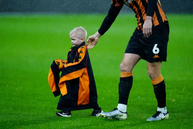 Hull player gives jacket to a mascot