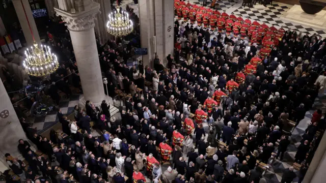 French firefighters attend the reopening ceremony of the Notre Dame de Paris Cathedral, following the 2019 fire, in Paris