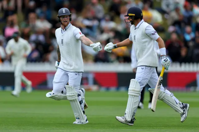 Ben Stokes and Joe Root punch gloves