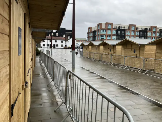 A row of closed Christmas market stalls in Gloucester.