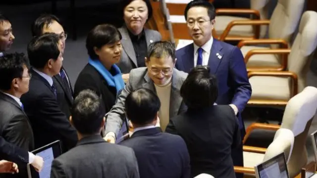 Kim Sang-wook is greeted by opposition party members after casting his vote on the impeachment motion