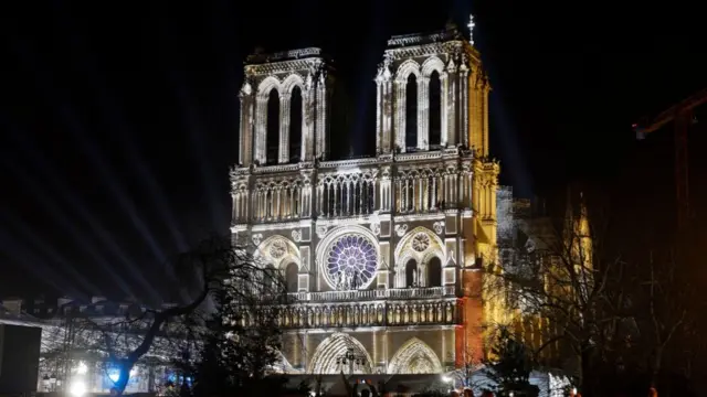 Notre-Dame cathedral by night illuminated by curated set of lights ahead of its reopening