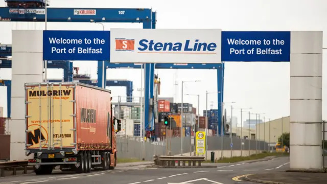 Lorry driving under a sign that says "Stena Line, Welcome to the Port of Belfast"