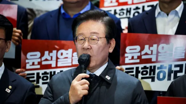 Opposition Democratic Party leader Lee Jae-myung addresses crowd outside the National Assembly in Seoul after the impeachment vote failed