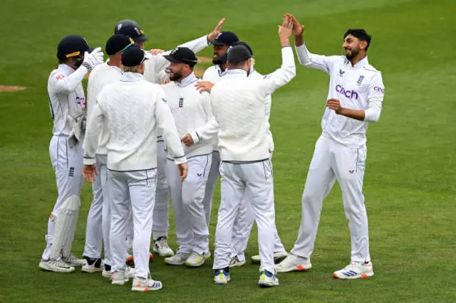 Shoaib Bashir of England celebrates with his team after dismissing Tom Blundell