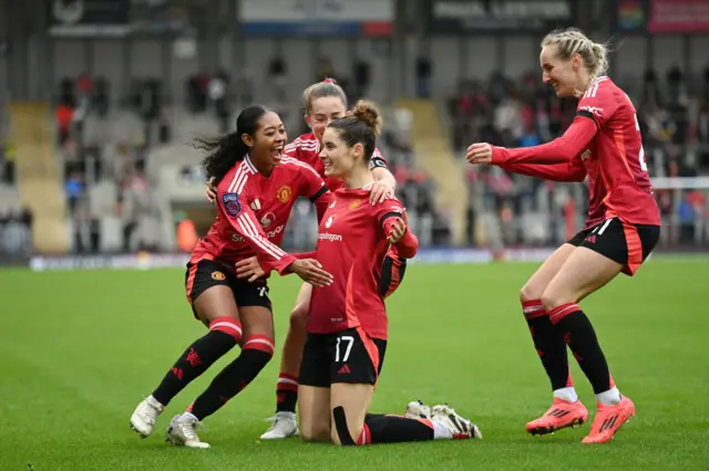 Dominique Janssen of Manchester United celebrates scoring her team's third goal