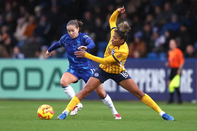 Chelsea's Guro Reiten and Brighton and Hove Albion's Maisie Symonds battle for the ball