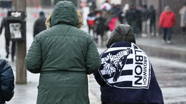 Fans arrive at The Hawthorns in the rain