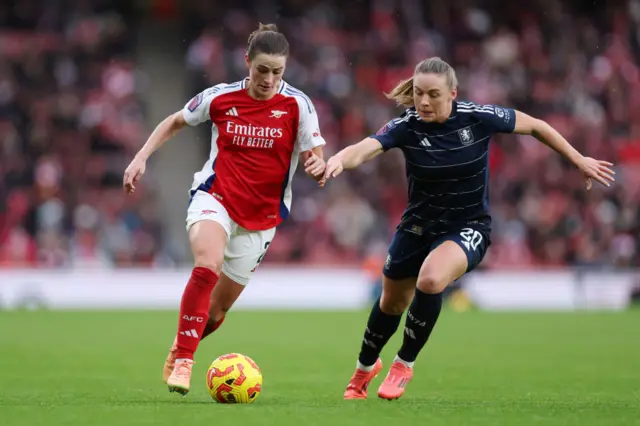 Emily Fox of Arsenal battles for possession with Kirsty Hanson of Aston Villa