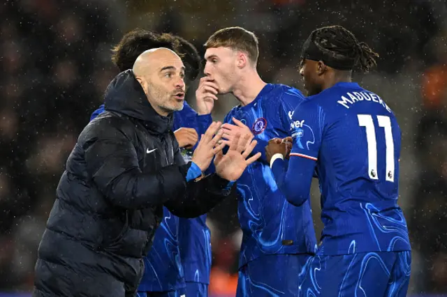 Enzo Maresca, Manager of Chelsea, speaks to Noni Madueke.