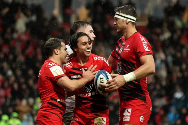 Ange Capuozzo celebrates scoring a try with Antoine Dupont and Alexandre Roumat