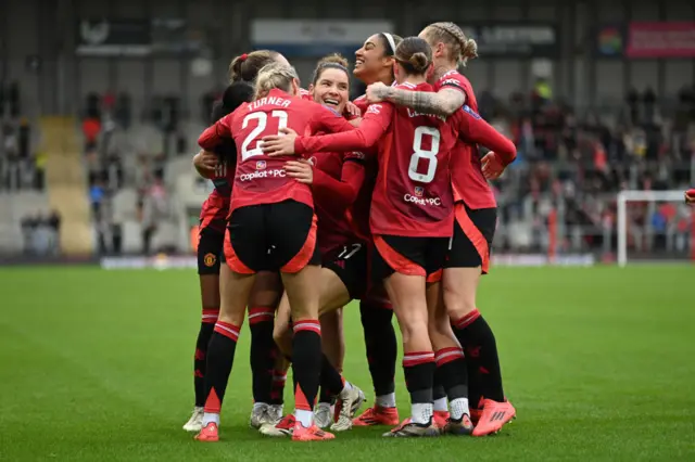 Dominique Janssen of Manchester United celebrates scoring her team's third goal