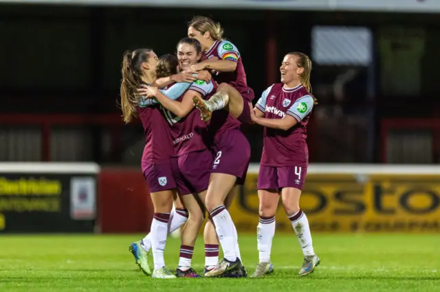 Anouk Denton of West Ham United celebrates with teammates after scoring to make it 4-2