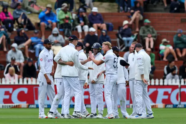 Ben Stokes of England celebrates with his team after dismissing Matt Henry