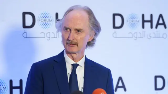 Geir Pedersen is pictured in this file photo. He is standing in front of a backdrop with the logo for the Doha Forum.