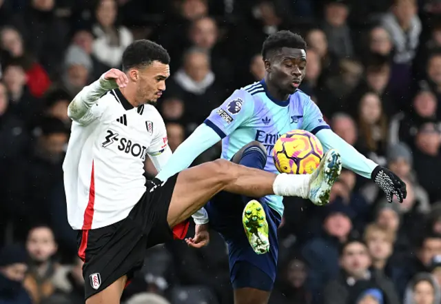 Bukayo Saka of Arsenal battles for possession.