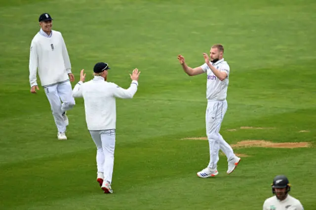 Gus Atkinson and Ben Stokes of England celebrate after dismissing Daryl Mitchell of New Zealand