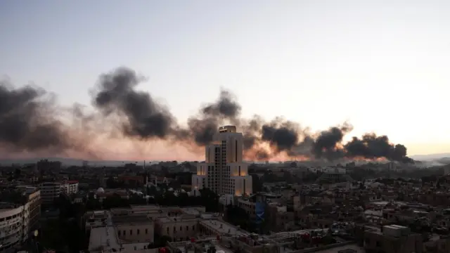 Thick plan smoke rising over Damascus