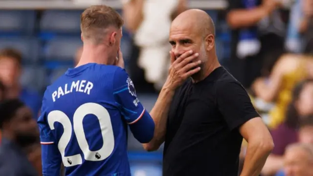 Cole Palmer and Pep Guardiola try to have a private conversation, with hands over their mouths, during a pre-season game between Chelsea and Manchester City