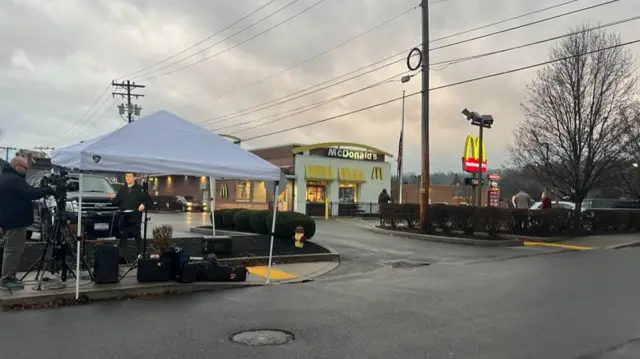 A shot of the exterior of McDonald's, with media tents visible outside, in Altoona, Pennsylvania where the suspect was arrested