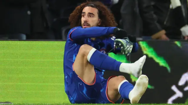 Marc Cucurella changes his boots at Tottenham