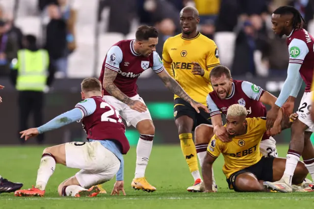 players try to separate rival captains Jarrod Bowen of West Ham United and Mario Lemina of Wolverhampton Wanderers as they scuffle