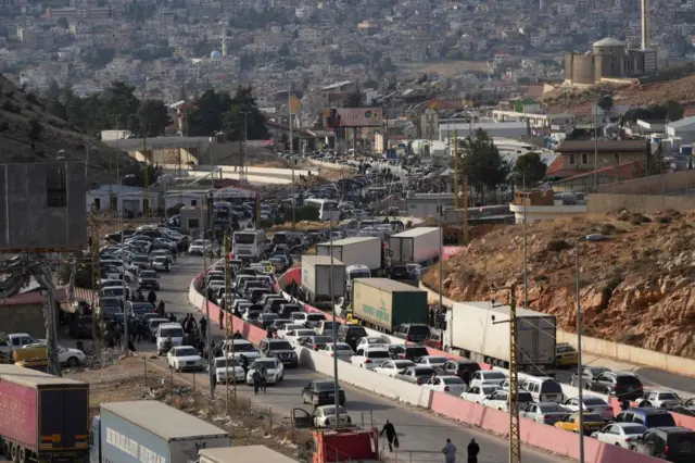 Dozens of cars queue up to cross into Lebanon at the Masnaa border crossing