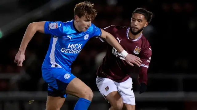 Northampton's Tyler Roberts battles with Peterborough's Hector Kyprianou