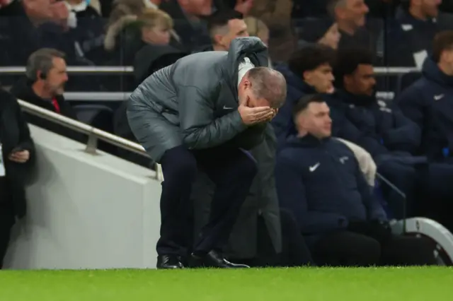 Ange Postecoglou with his head in his hands