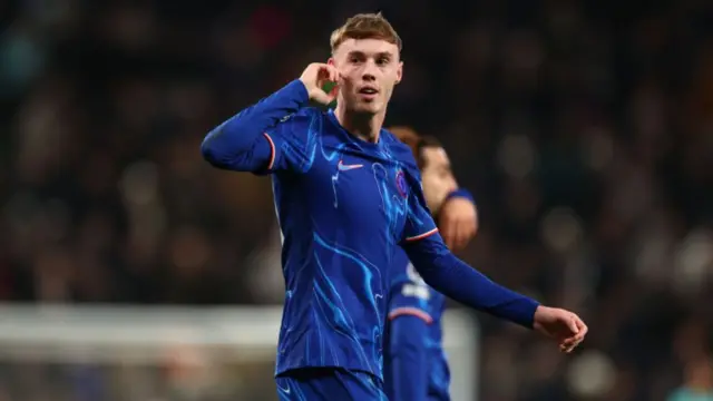 Cole Palmer cups his ear during Tottenham v Chelsea