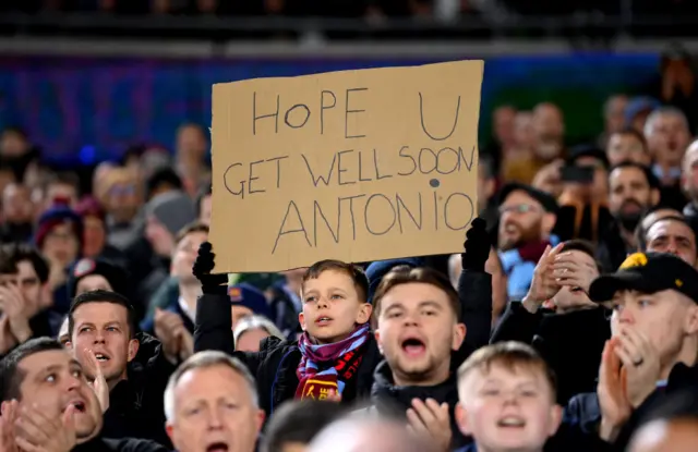 A fan of West Ham United holds up a sign in support of Michail Antonio