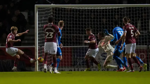 Cameron McGeehan finishes at the back post for Northampton