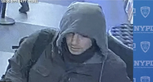 A man wearing a dark hoodie and black rucksack can be seen on CCTV footage