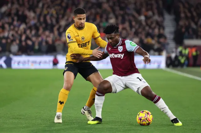 Mohammed Kudus of West Ham United holds off a challenge from Joao Gomes of Wolverhampton Wanderers