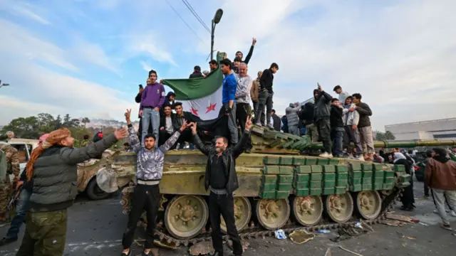 - People celebrate with anti-government fighters at Umayyad Square in Damascus