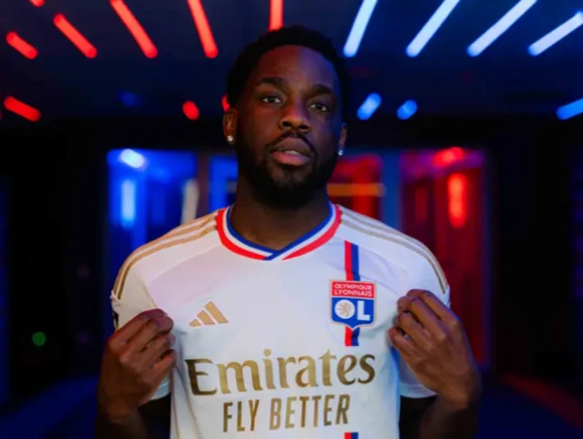 Orel Mangala poses in a Lyon shirt