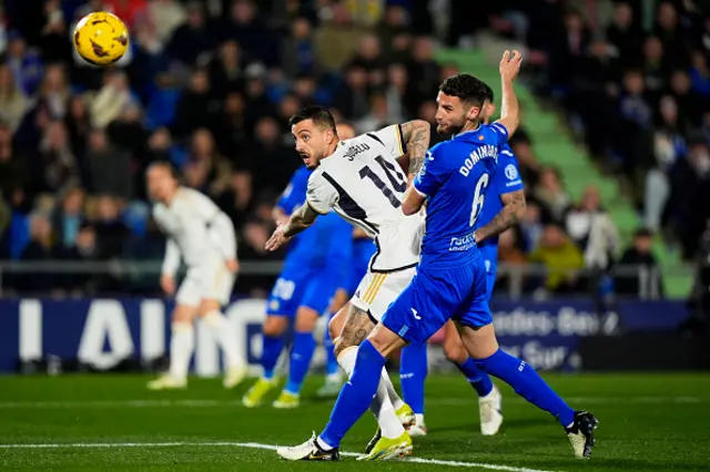 Domingos Duarte of Getafe CF battle for the ball with Joselu Mato