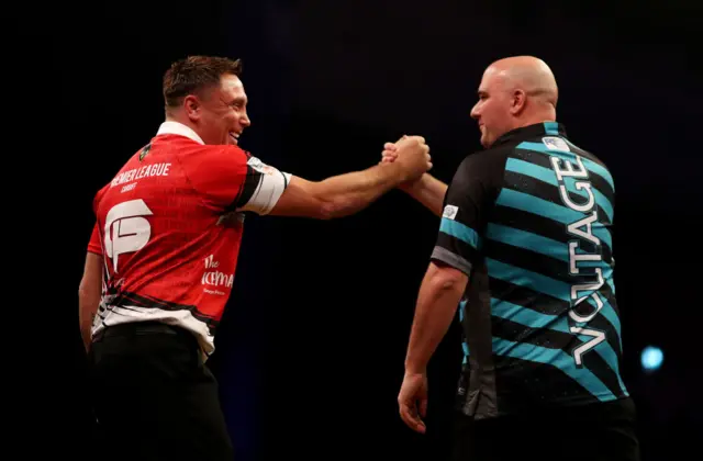 Gerwyn Price shakes hands with Rob Cross