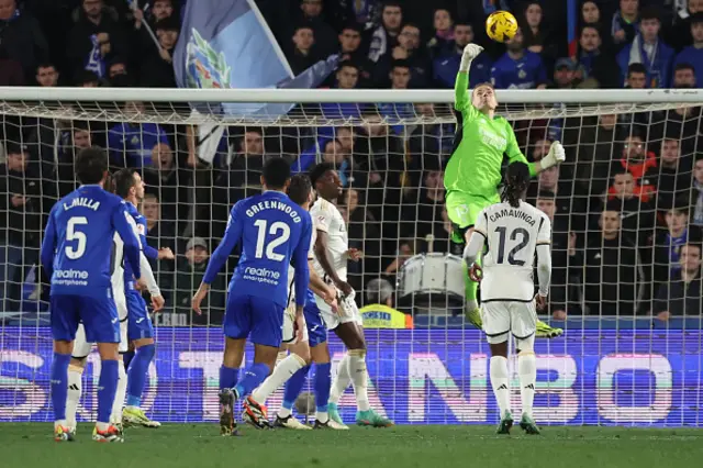 Andriy Lunin deflects the ball