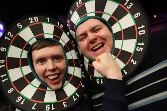 Fans wearing dart board hats