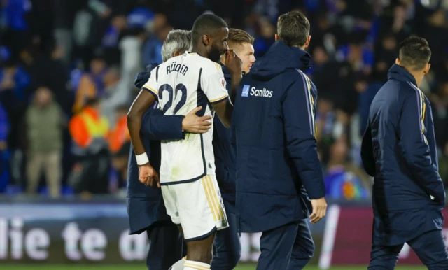 Rudiger walks off with the medical team