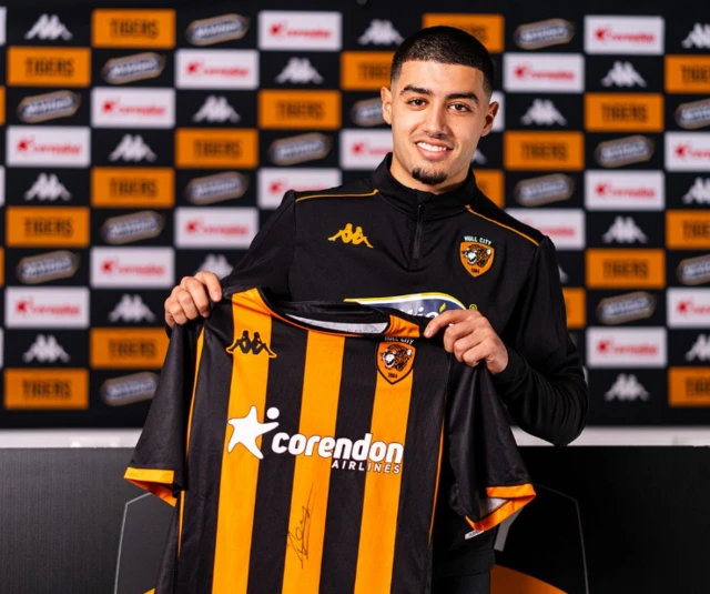 Anass Zaroury poses with a Hull City shirt