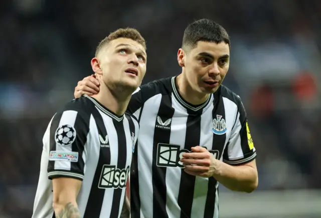 Newcastle United's Miguel Almiron whispers to Kieran Trippie